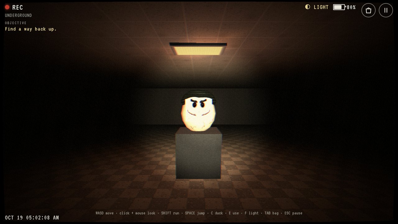 A detached mascot head sitting on a pedestal in a containment cell.